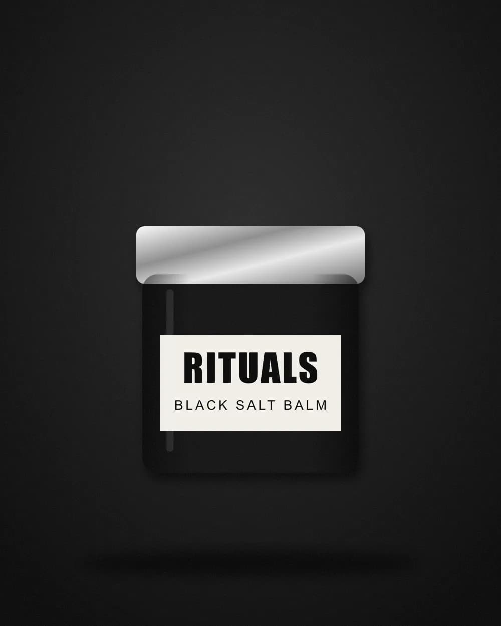 Black jar with a silver lid and a paper label reading Rituals Black Salt Balm